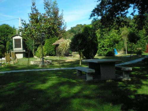 a picnic table in the grass in a park at Iberik Casa Vilamor in Vilamor