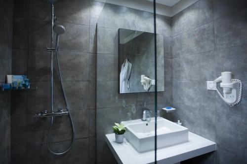 a bathroom with a sink and a shower at La Cigale Tabarka in Tabarka