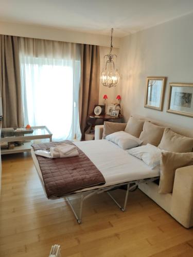 a living room with a large bed and a couch at Unique Apartment in the Heart of the City in Rhodes Town