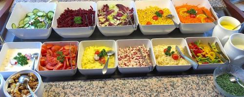 a bunch of containers filled with different types of food at Hotel Schwarzer Adler in Pettneu am Arlberg