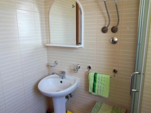 a bathroom with a sink and a mirror at Apartments Pure Magic in Utjeha