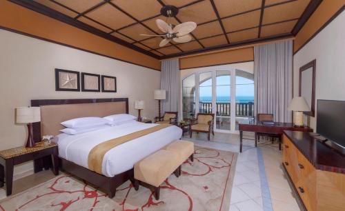 a hotel room with a bed and a television at Anantara Desert Islands Resort & Spa in Da‘sah