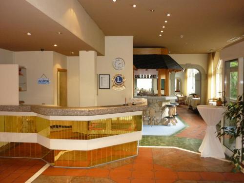 a large kitchen and living room with a counter at Abakus-Hotel in Sindelfingen