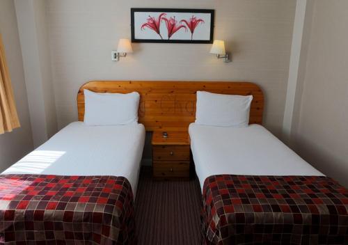 two beds in a hotel room with sidx sidx sidx sidx at King Charles Hotel in Gillingham