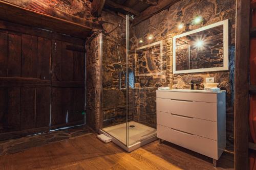 a bathroom with a shower and a sink at Cabo Do Mundo Casa Rural in Chantada