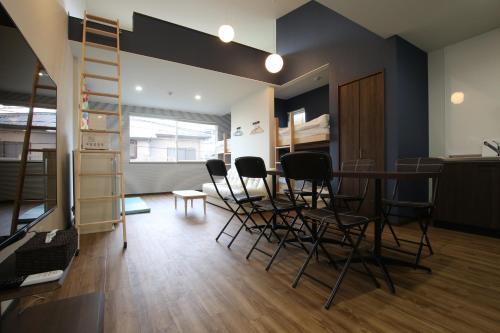 a room with chairs and a table and a ladder at Tiz wan 岩屋あわじ in Awaji