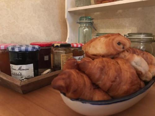 a bowl of croissants and other breads in a refrigerator at Chambres d'Hôtes Belle Vallee in Domfront