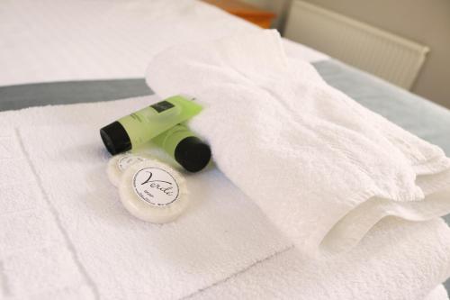 a white towel with a camera on a bed at The Oyster Smack in Burnham on Crouch