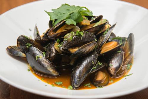 a plate of food with mussels on a table at Babbity Bowsters in Glasgow