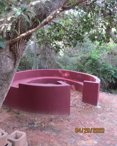 a red tub sitting next to a tree at East Africa Safaris in Chizavane