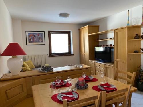 a kitchen with a table and a dining room at Casa Bracchi in Valdisotto