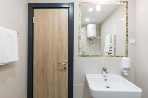 a bathroom with a sink and a mirror at Premium Crown Suites in Belgrade