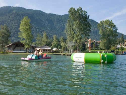 people are riding on inflatable boats on a lake at Aparthotel Buchauer-Tirol in Thiersee