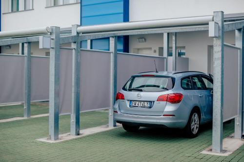 a small silver car parked under a building at Diamante MHotel in Collegno