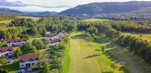an aerial view of a house and a golf course at Macdonald Spey Valley Resort in Aviemore
