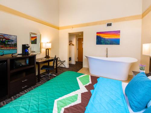 a hotel room with a bath tub and a bed at Country Cascades Waterpark Resort in Pigeon Forge