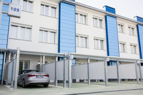 a car parked in front of a building at Diamante MHotel in Collegno
