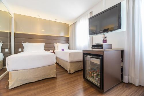 Ένα ή περισσότερα κρεβάτια σε δωμάτιο στο Mercure Sao Paulo Vila Olimpia