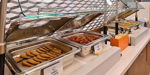 a buffet with cookies and other food on a counter at Holiday Inn Express & Suites - Madison West - Middleton by IHG in Middleton