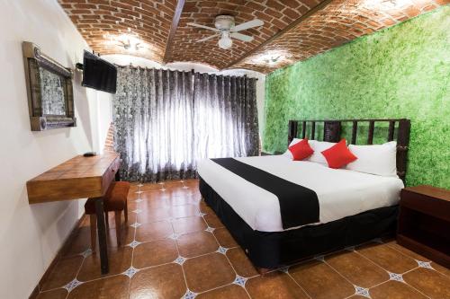 Postel nebo postele na pokoji v ubytování Hotel Hacienda Tonalmain, Central Nueva