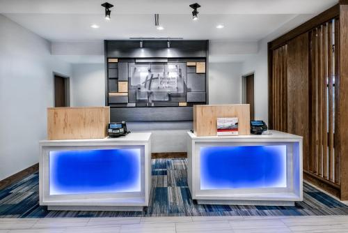 a lobby with two reception desks and a television at Holiday Inn Express & Suites Round Rock - Austin N by IHG in Round Rock