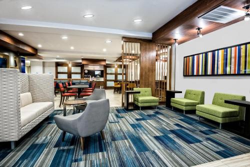 a lobby of a hotel with chairs and tables at Holiday Inn Express & Suites Round Rock - Austin N by IHG in Round Rock