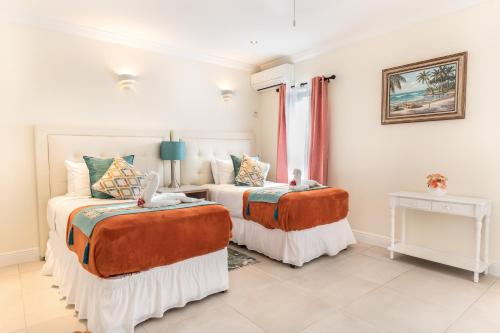 a bedroom with two beds and a window at Bay Gardens Beach Resort & Spa in Gros Islet