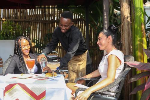 a group of people sitting around a table at The Swiss Hotel Freetown in Freetown