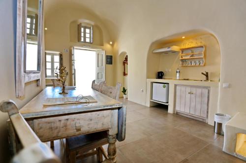 a kitchen with a sink and a counter in a room at Oia Mare Villas in Oia