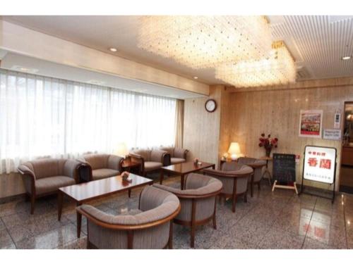 a restaurant with tables and chairs in a room at Sky Heart Hotel Kawasaki / Vacation STAY 80810 in Kawasaki