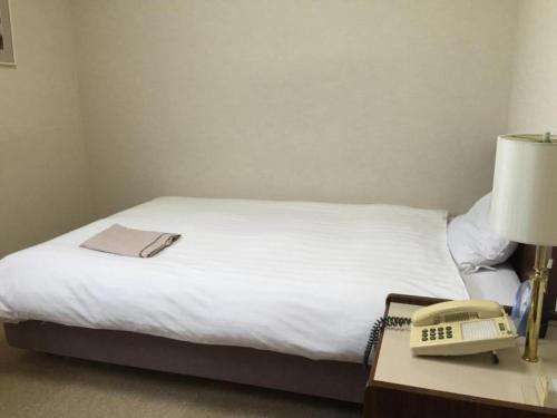 Postel nebo postele na pokoji v ubytování Sky Heart Hotel Kawasaki / Vacation STAY 80788