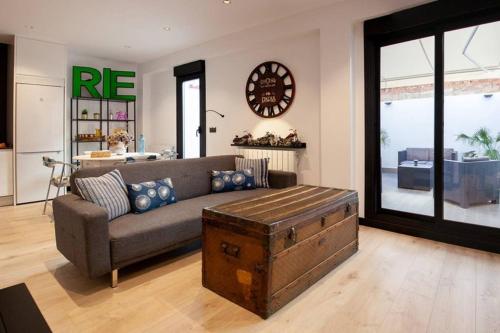 a living room with a couch and a large window at LOFT MON in Zaragoza