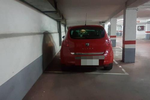 a red car parked in a parking garage at LOFT MON in Zaragoza