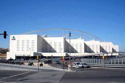 a large white building with cars parked in a parking lot at LOFT MON in Zaragoza