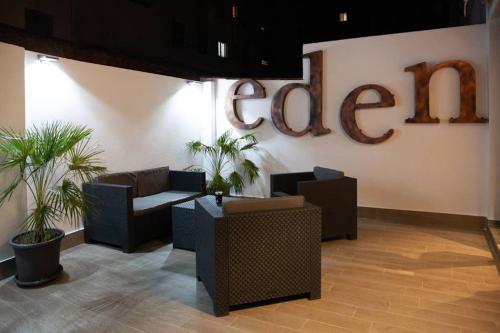 a lobby with couches and plants and a sign on a wall at LOFT MON in Zaragoza