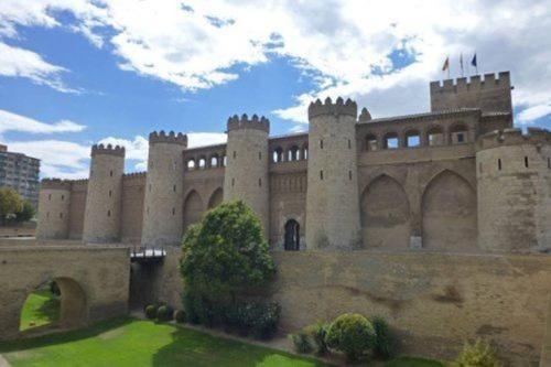a castle with a bunch of towers and a bridge at LOFT MON in Zaragoza
