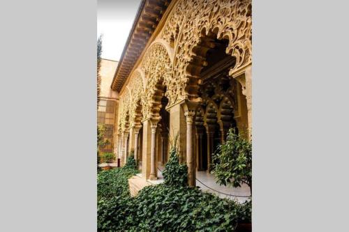 a building with ivy growing on the side of it at LOFT MON in Zaragoza