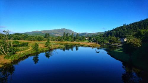 a view of a river with mountains in the background at Riverbank in Callander