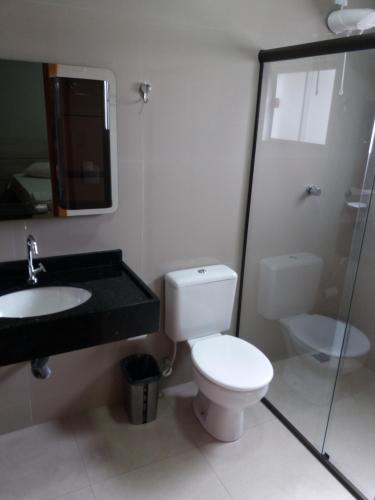 a bathroom with a toilet and a sink and a shower at Sleep Hotel in Toledo