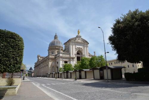 a large building with a dome on a street at Camere Paolo in Assisi