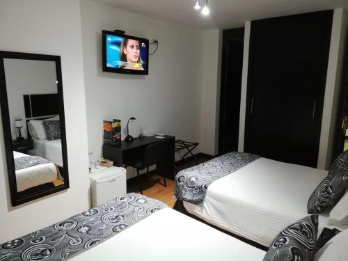 Cama o camas de una habitación en Hotel Santafe Real