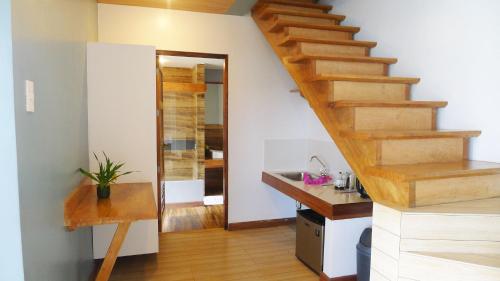 
a hallway with a staircase leading to a kitchen at La Estancia Busuanga in Busuanga
