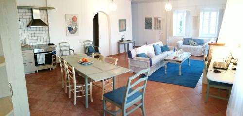 a kitchen and living room with a table and chairs at Pine Trees and Sea View Houses in Hydra - Daphne, Chloe, Myrto, Eleni in Hydra