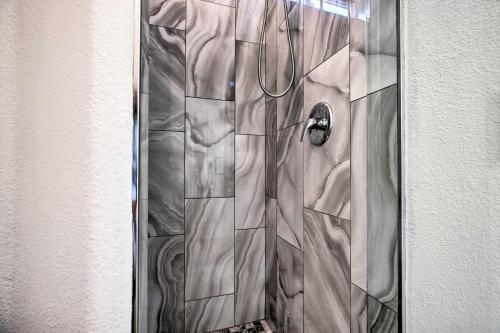 a shower with a glass door with a shower at Modern Sun City Studio Near Deer Valley Golf in Sun City West