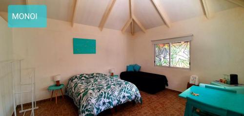 a bedroom with a bed and a window at Hotel & Apartments "CHEZ HIVA" in Hanga Roa