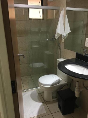 a bathroom with a shower and a toilet and a sink at Atlântico Flat 110 in Natal