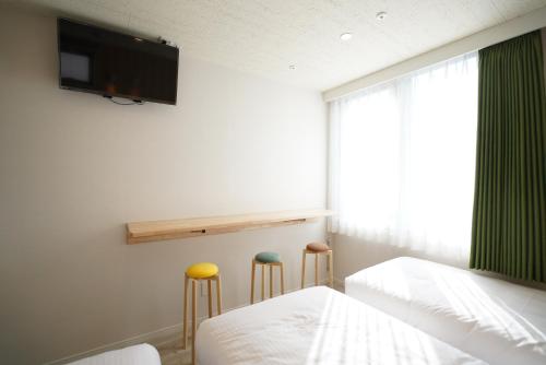 Ένα ή περισσότερα κρεβάτια σε δωμάτιο στο U-Hotel Takadanobaba