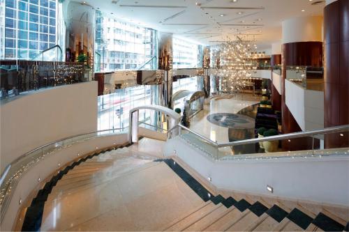 a lobby with a spiral staircase in a building at B P International in Hong Kong