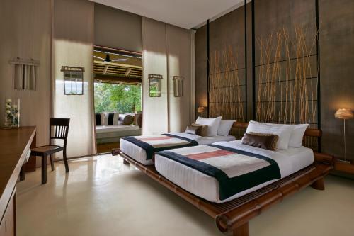 Una cama o camas en una habitación de Kirimaya Golf Resort Spa - SHA Plus Certified