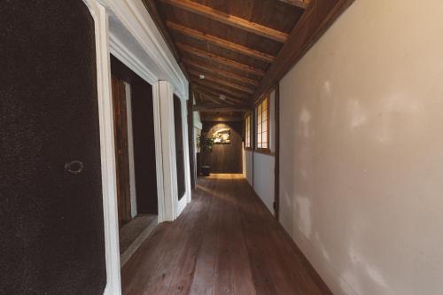 an empty hallway of a house with a wooden ceiling at NIPPONIA Kosuge Village in Kosuge